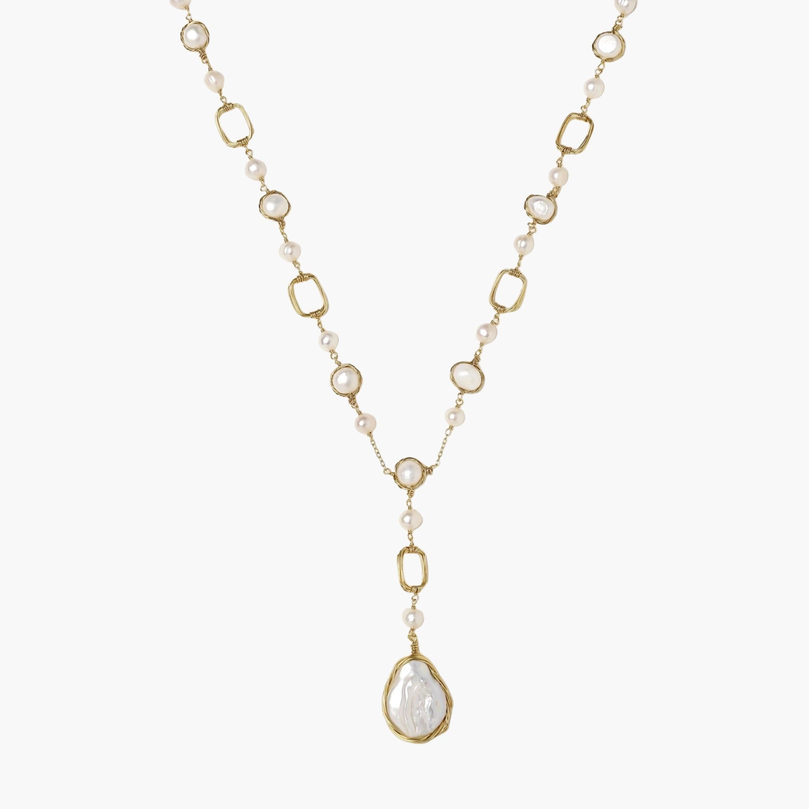 Long gold-plated necklace with alternating freshwater pearls and crystal bezels, featuring a large baroque pearl pendant