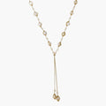 Adjustable gold lariat necklace with freshwater pearls nested in delicate cage settings and Y-shaped tassel drop