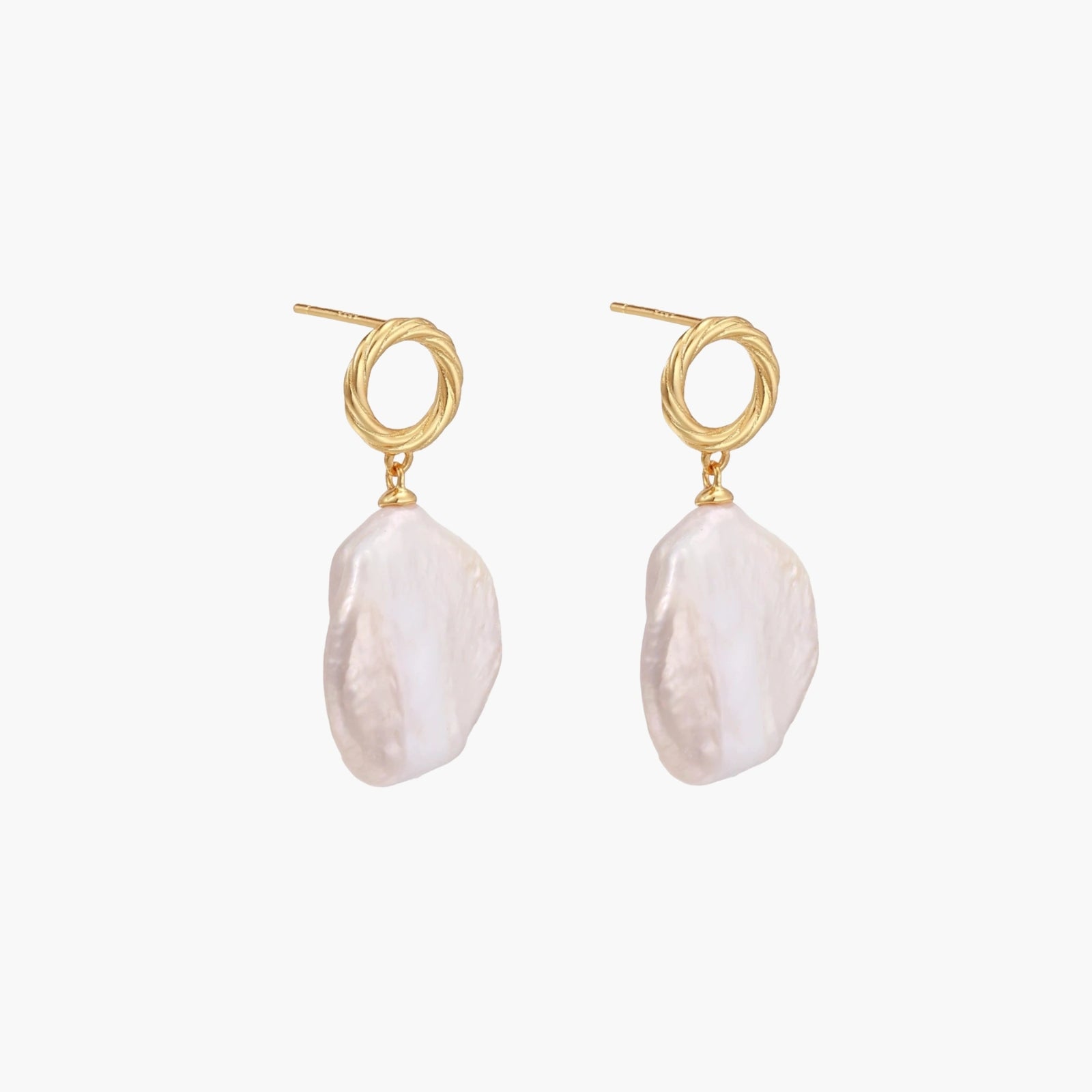 18K gold vermeil twisted circle studs with organic white baroque pearl drops on cream background