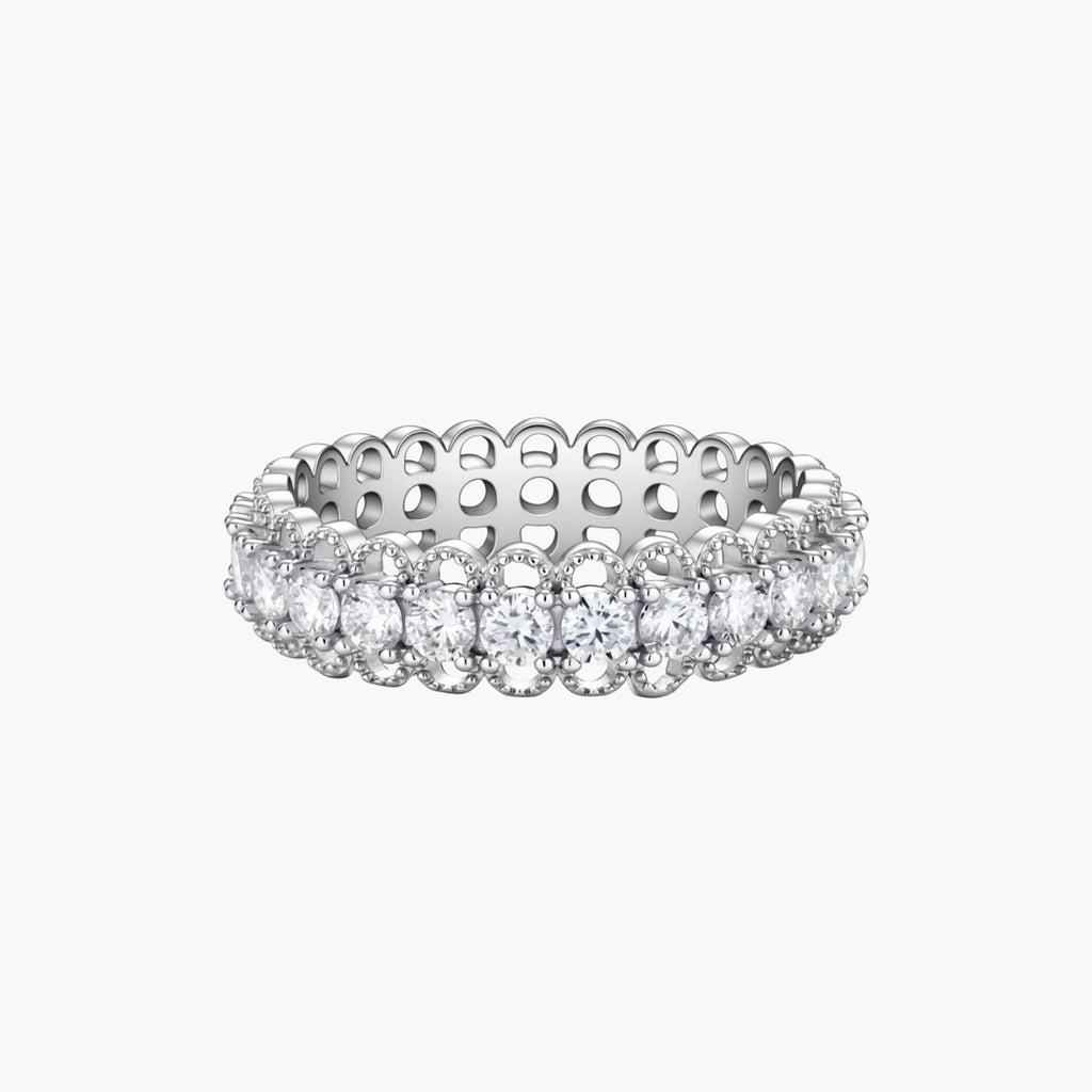 Sterling silver eternity ring with continuous row of brilliant moissanite stones in scalloped crown setting with milgrain detail