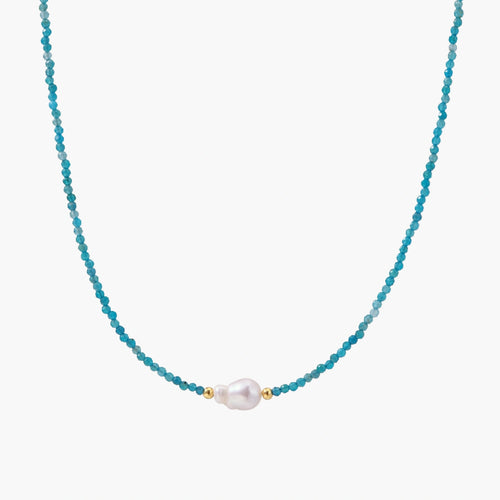 Delicate gold vermeil necklace with teal apatite beads and freshwater pearl on white background.