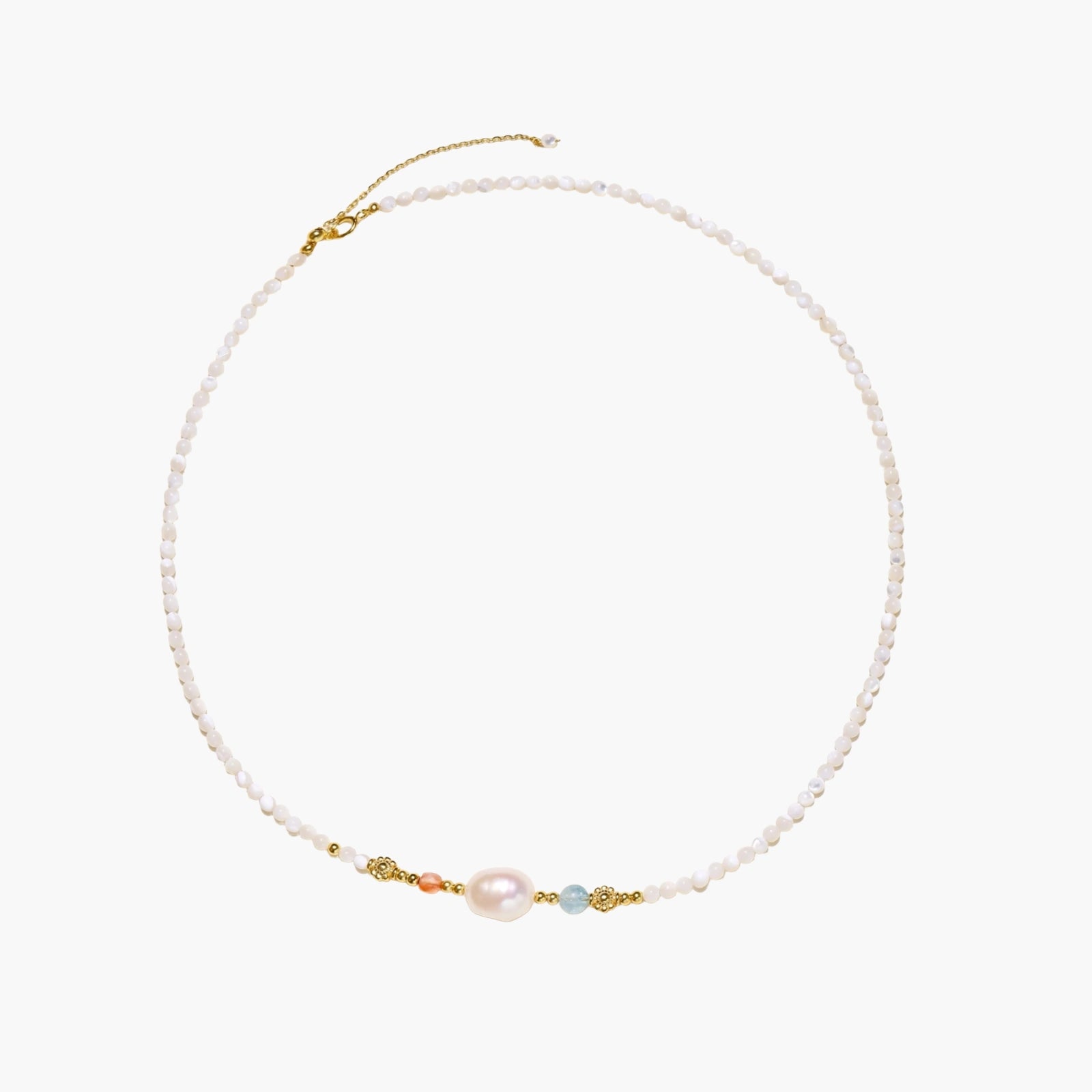 Delicate white beaded necklace with baroque pearl center, gold accents, and coral and aqua gemstones on cream background.
