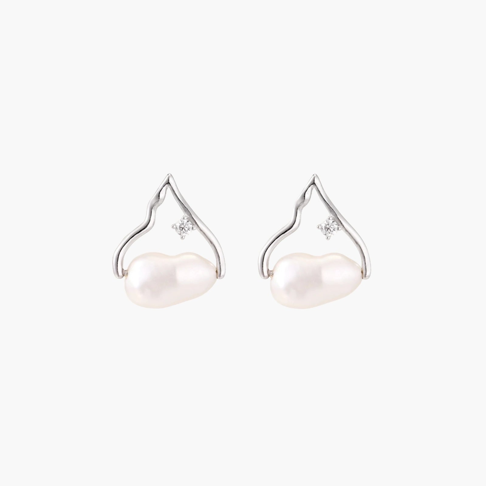 Silver mountain outline studs with baroque pearl and diamond accent on white background