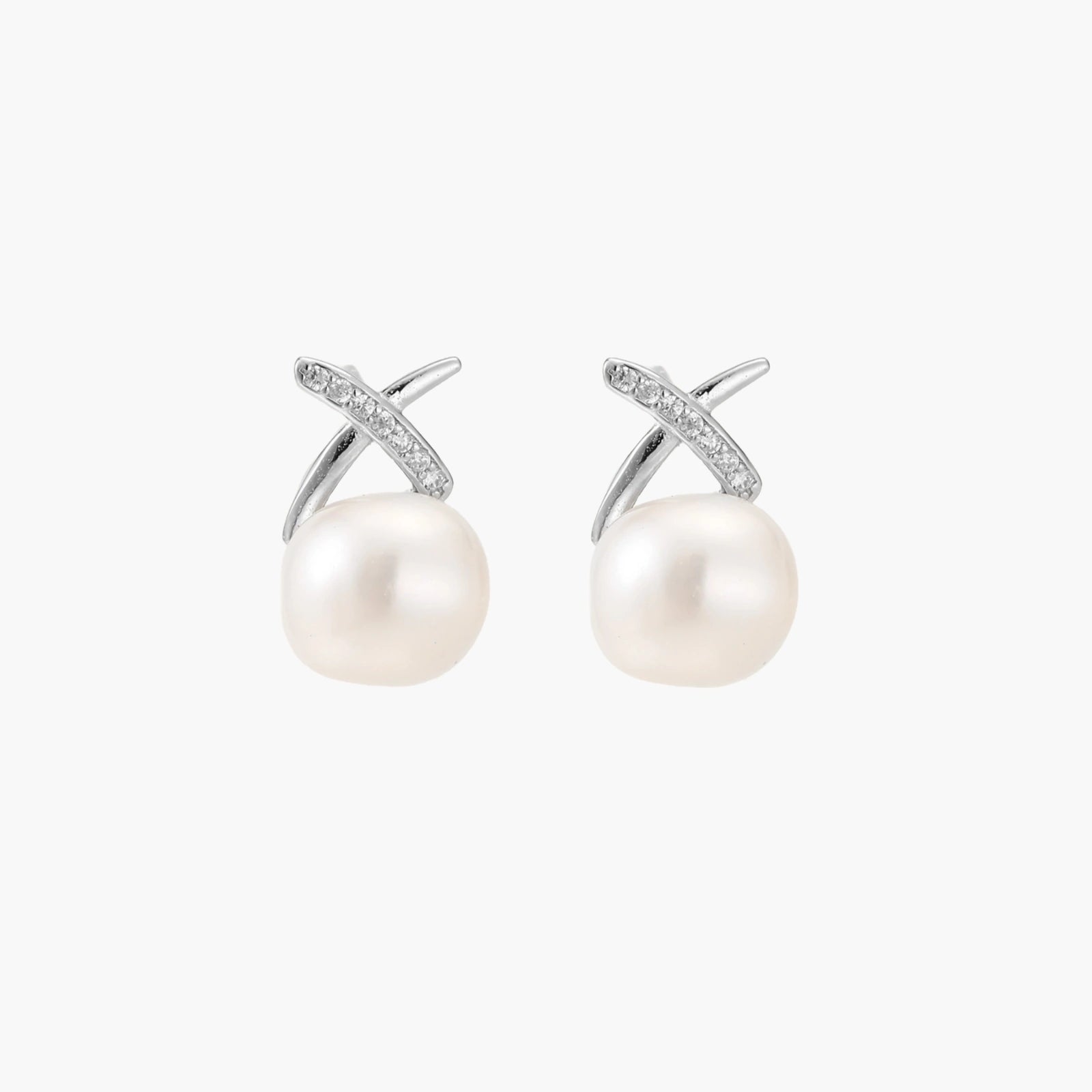 Rhodium-plated silver stud earrings with sparkling X design above lustrous round freshwater pearls on white background.