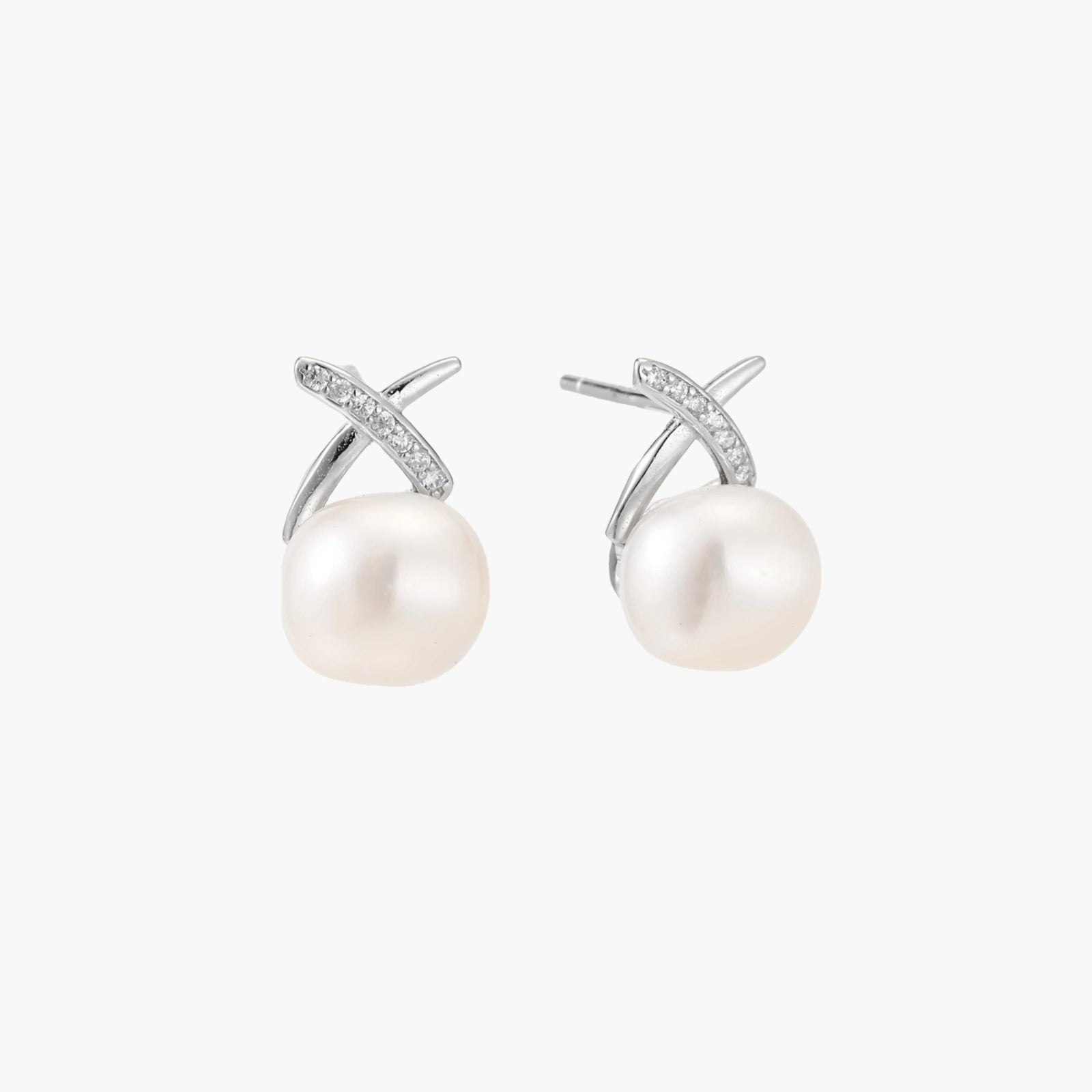 Rhodium-plated silver stud earrings with sparkling X design above lustrous round freshwater pearls on white background.