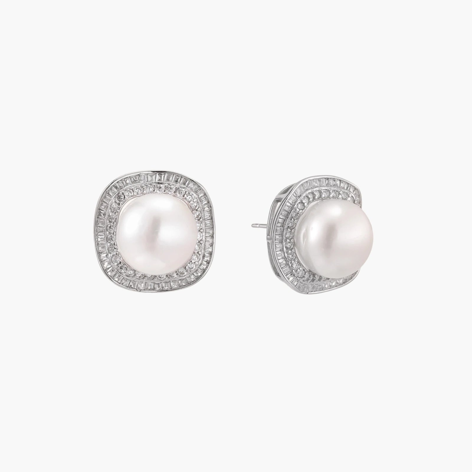 Rhodium-plated sterling silver stud earrings with round freshwater pearls surrounded by geometric crystal halos on cream background.