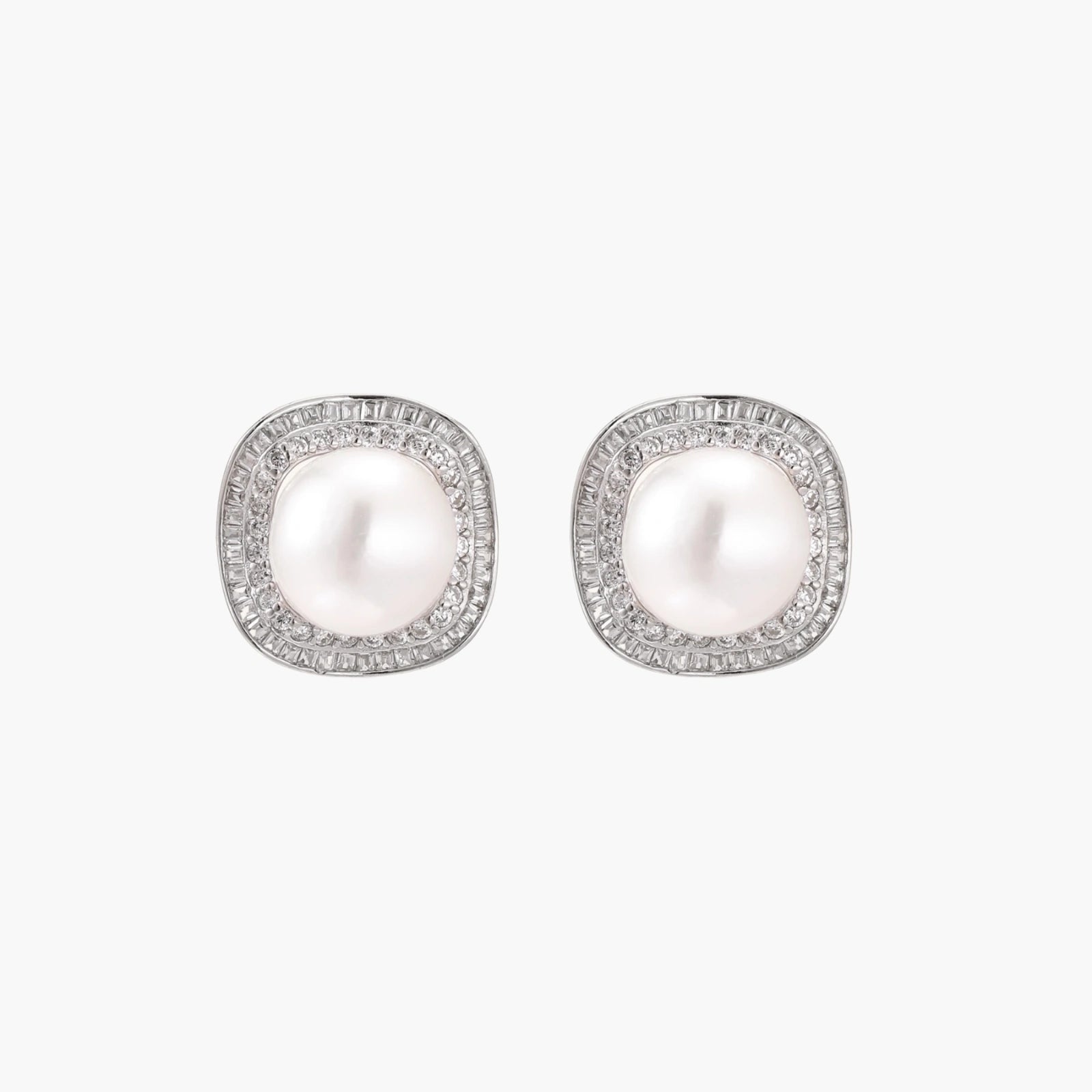 Rhodium-plated sterling silver stud earrings with round freshwater pearls surrounded by geometric crystal halos on cream background.