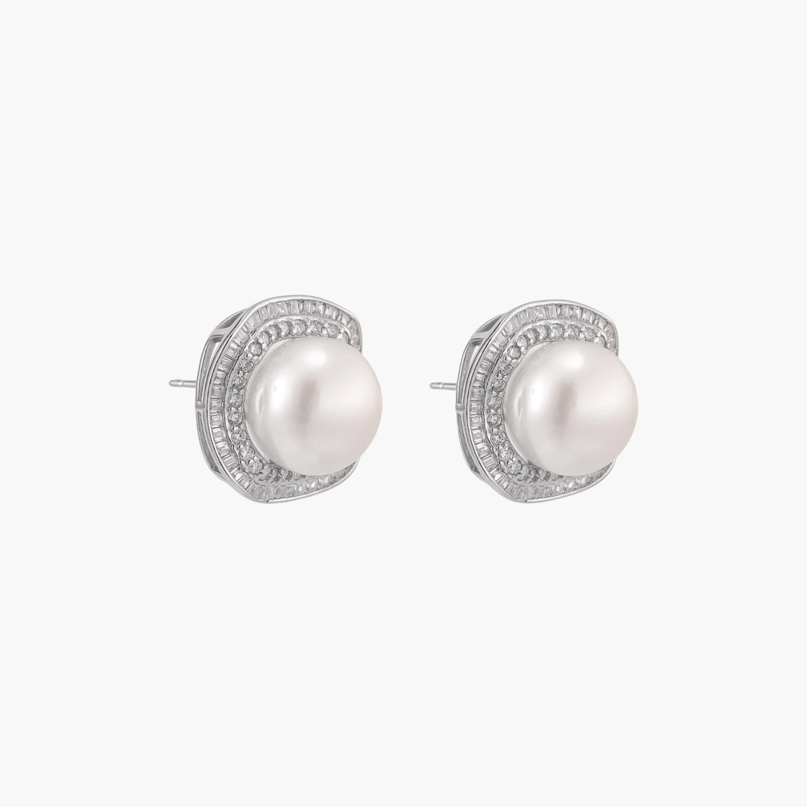 Rhodium-plated sterling silver stud earrings with round freshwater pearls surrounded by geometric crystal halos on cream background.