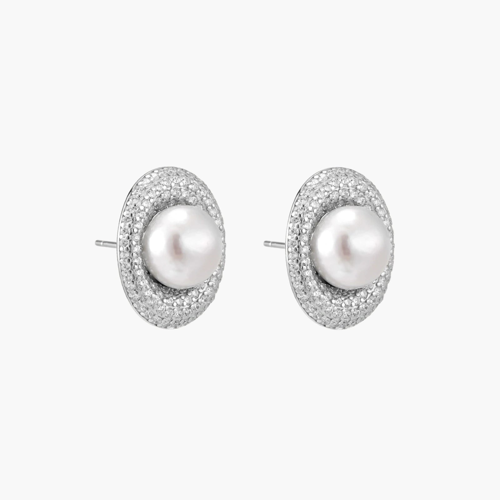Elegant stud earrings with cream freshwater pearls surrounded by sparkly pavé crystals on rhodium-plated silver setting