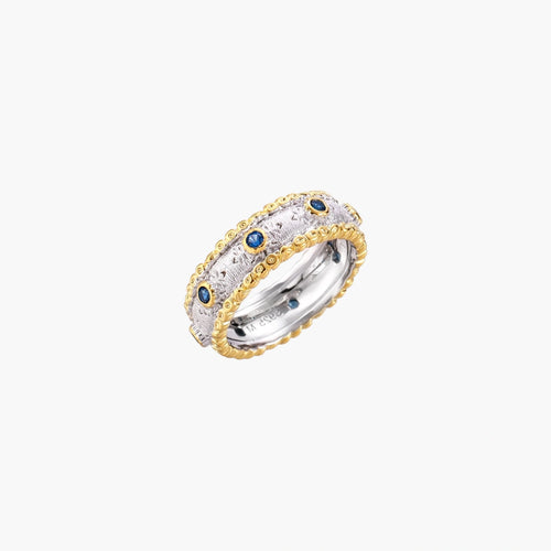 Two-tone ring with brushed silver center, gold beaded edges, and blue zirconia stones on white background.