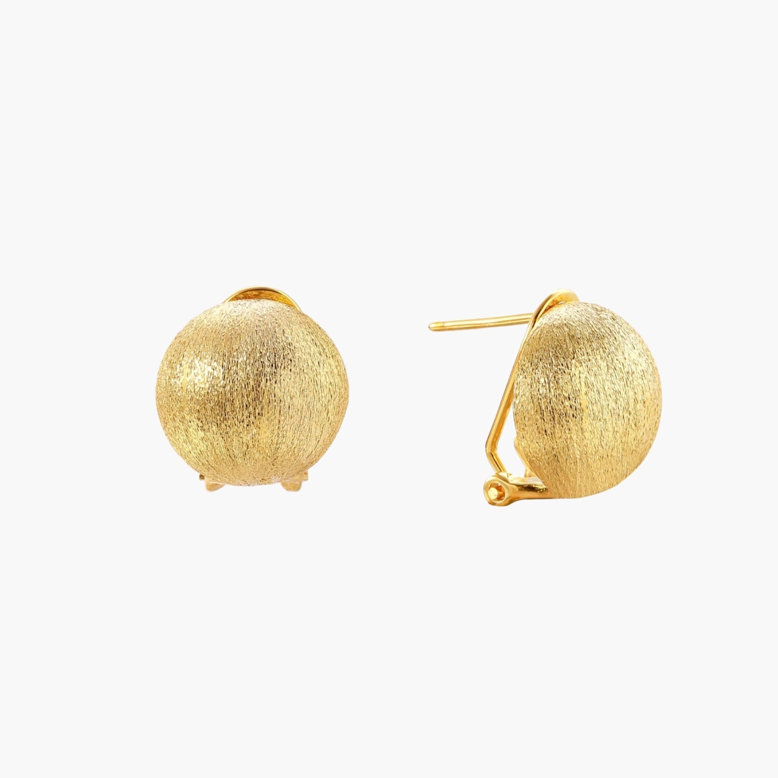 Pair of brushed gold dome earrings with clip backs showing textured matte finish on cream background