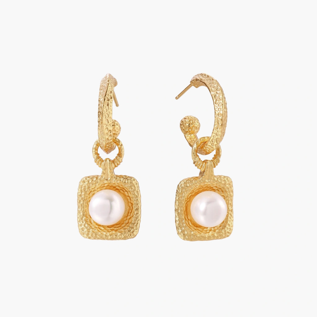 Pair of gold vermeil hoop earrings with textured square frames holding freshwater pearls on cream background