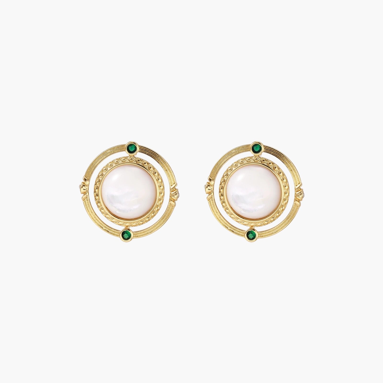 Circular gold stud earrings with iridescent mother-of-pearl center and green zirconia accents on cream background.