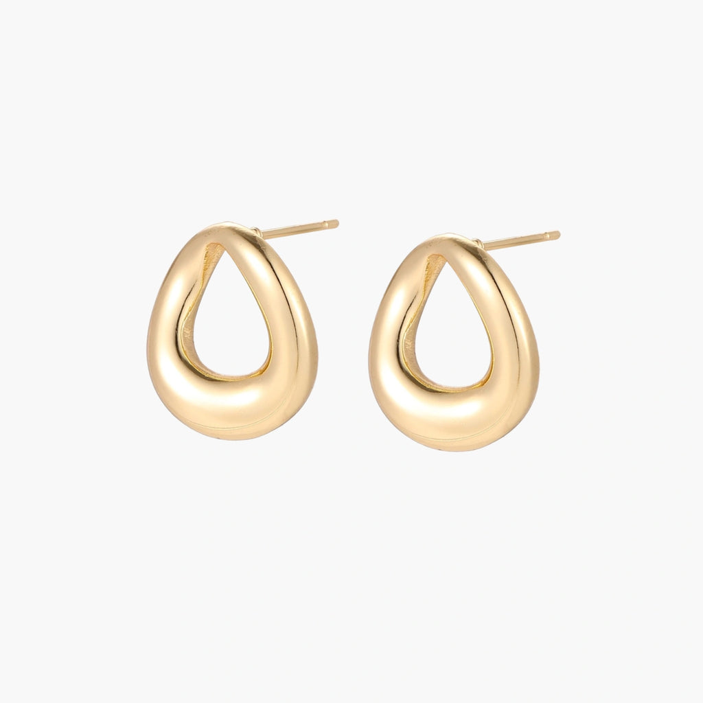 Pair of polished 18K gold-plated stainless steel teardrop earrings with hollow centers on cream background