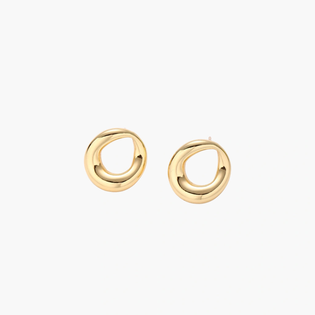 Pair of polished 18K gold-plated stainless steel teardrop earrings with hollow centers on cream background