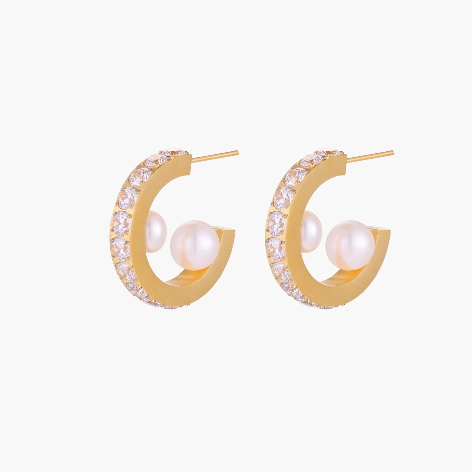 Gold pavé hoop earrings with two freshwater pearls nestled inside the curved design, featuring crystal-studded outer edge.